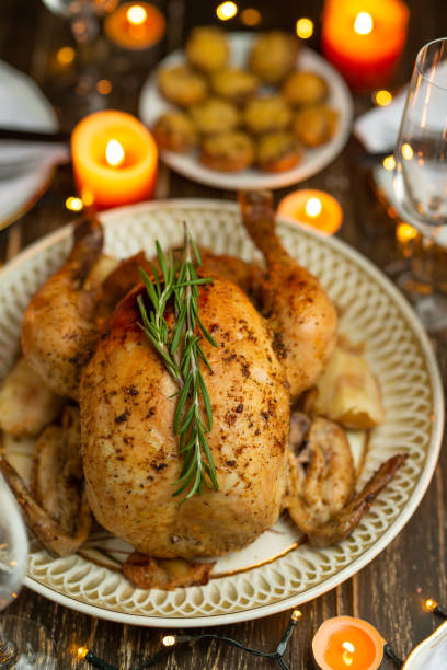 istock Festive baked chicken with rosemary on a festive table by candlelight 1089085808