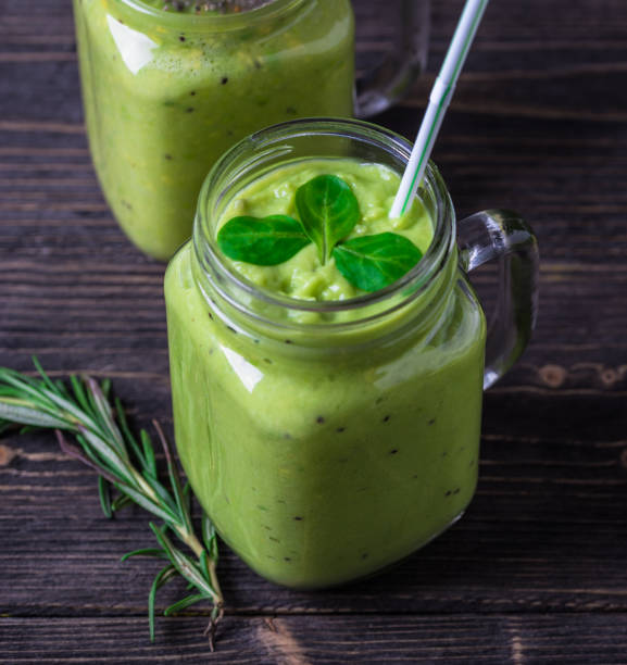 istock Green smoothie on green background made by avocado, lemon and kiwi. 1089091082