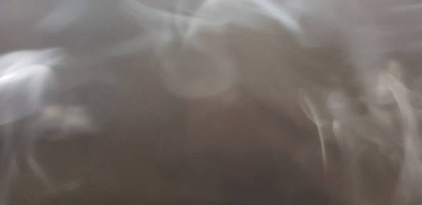 istock Wispy twirls of incense smoke against dark background with copy space 1089096806