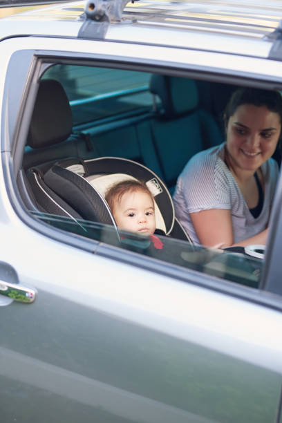 istock Mother with small kid on back car seat 1089100082