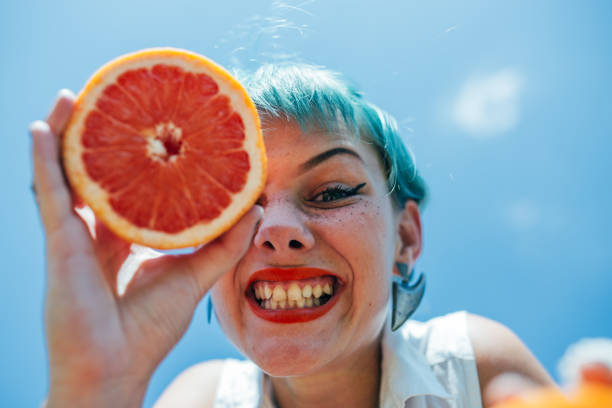 istock Charming young woman holding grapefruit 1089114728