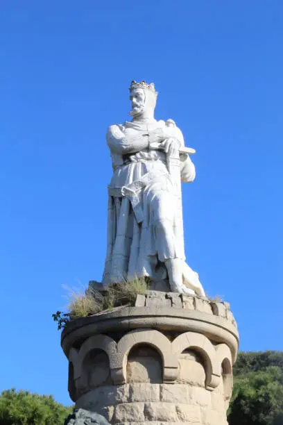 Photo of The concrete white statue of Alfonso the Battler, king of Aragon kingdom, dressed as a knight, in the Parque Grande city park in Zaragoza, Spain