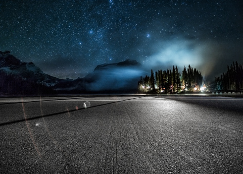 empty tarmac road under milky way by Emerald Lake in Yoho national park,British Columbia, Canada.