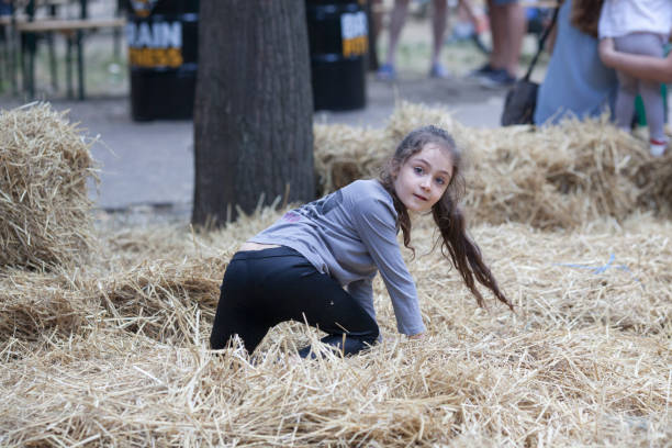 istock Little girl playing in the hay 1089121468