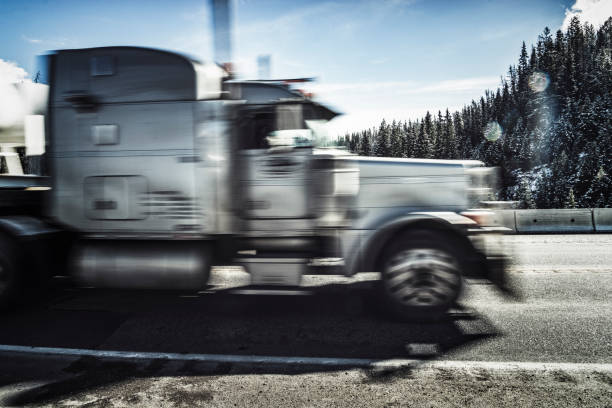 istock a white semi-truck driving on mountain road 1089122236