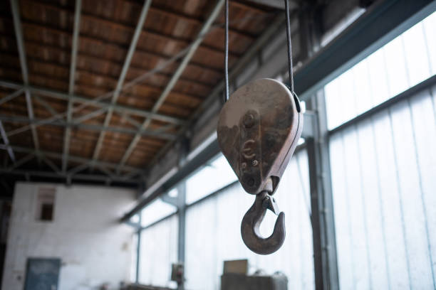 Germany: A crane for heavy loads hangs from the ceiling in an industrial building.