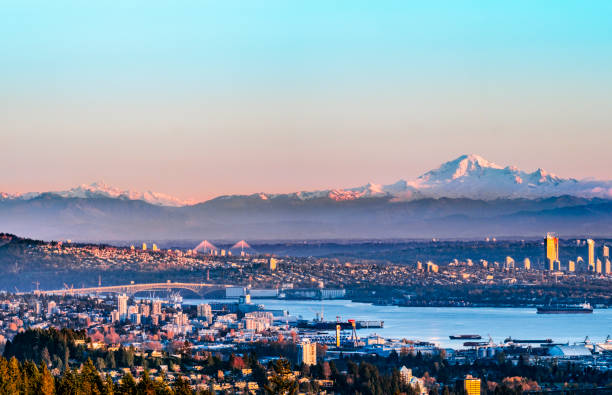 The North Vancouver skyline and ships in the harbour and snow mountains visible in the background Vancouver, British Columbia, Canada. vancouver canada stock pictures, royalty-free photos & images