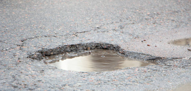 istock there are many potholes on the roadway close up 1089133196