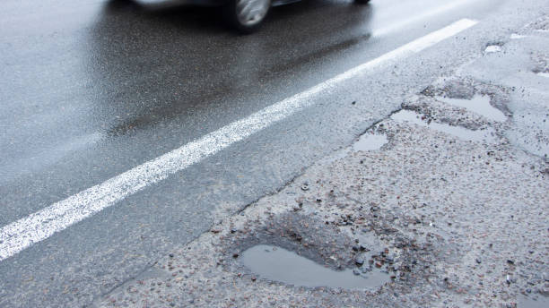 istock there are many potholes on the roadway close up 1089133202