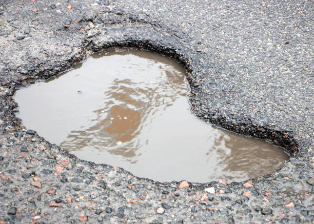 istock there are many potholes on the roadway close up 1089133216