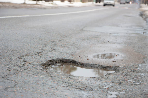 istock there are many potholes on the roadway close up 1089133218