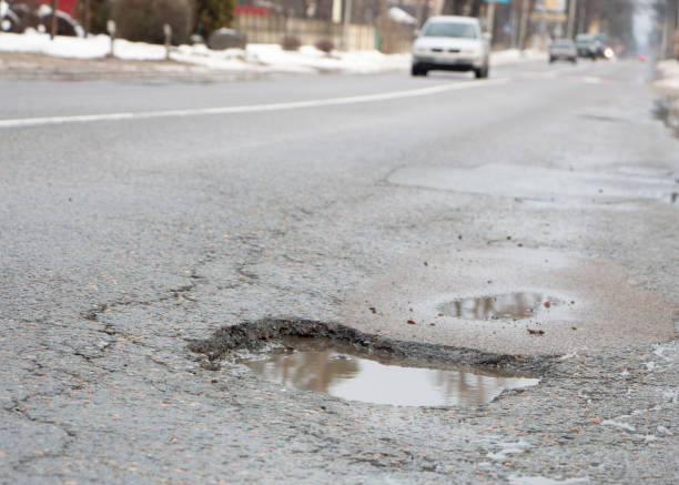 istock there are many potholes on the roadway close up 1089133220