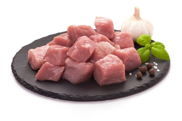 istock Raw pork pieces on stone plate, close-up, isolated on white background. 1089141488