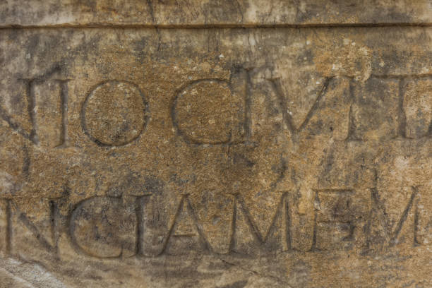 istock Real ancient letters cutted in stony wall of ancient architecture 1089147756