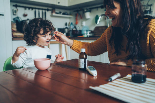istock Mother giving syrup to her son 1089150636