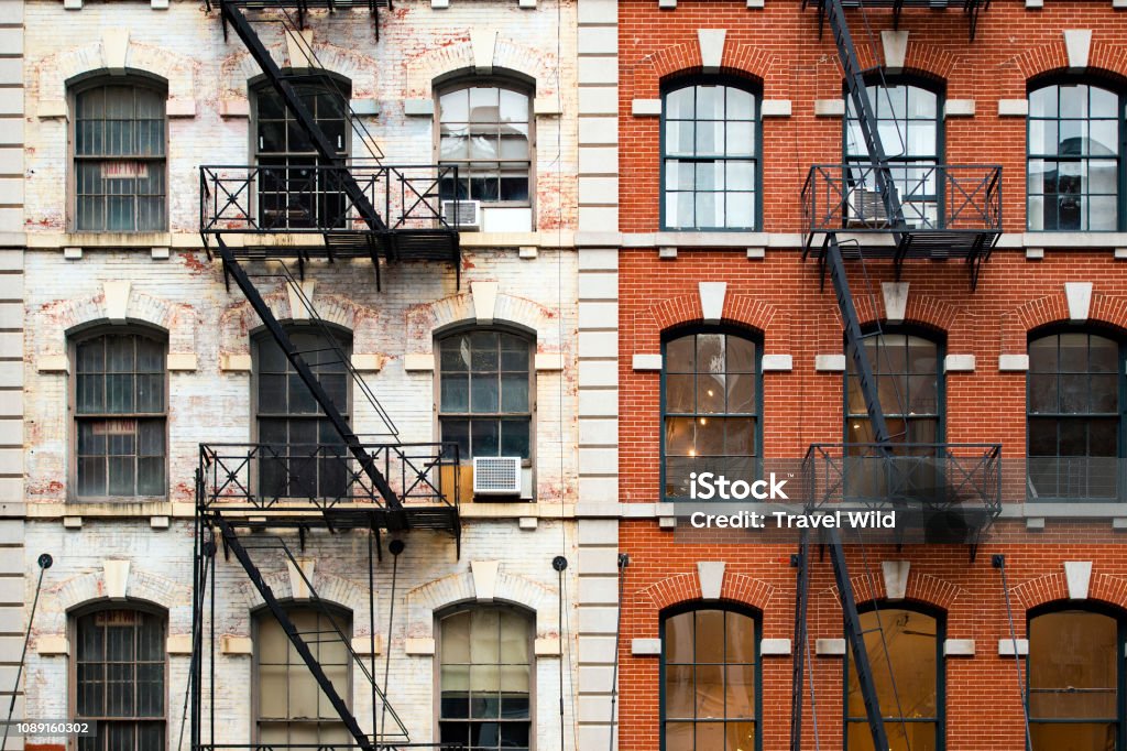 Close-up view of New York City style apartment buildings with emergency stairs along Mott Street in Chinatown neighborhood of Manhattan, New York, United States.. New York City Stock Photo
