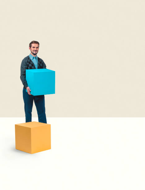 Man holding a box container. Man stacking boxes in a white room. Moving concept or relocation of storage boxes. Text boxes in a studio. stackable stock pictures, royalty-free photos & images