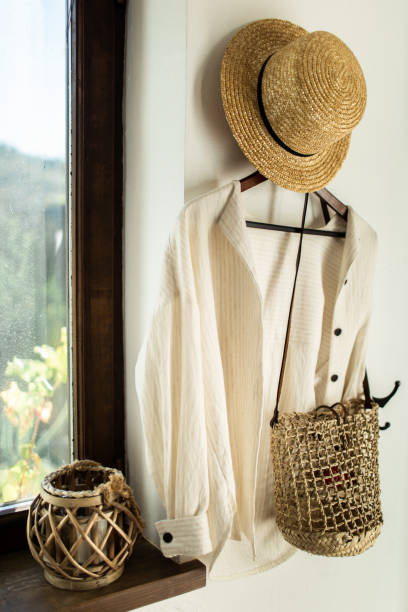 istock wicker hat and bag hang on a white wall in the hallway at home 1089163676