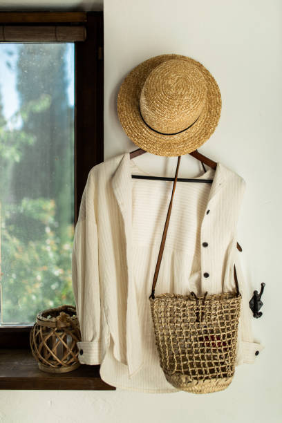 istock wicker hat and bag hang on a white wall in the hallway at home 1089163678