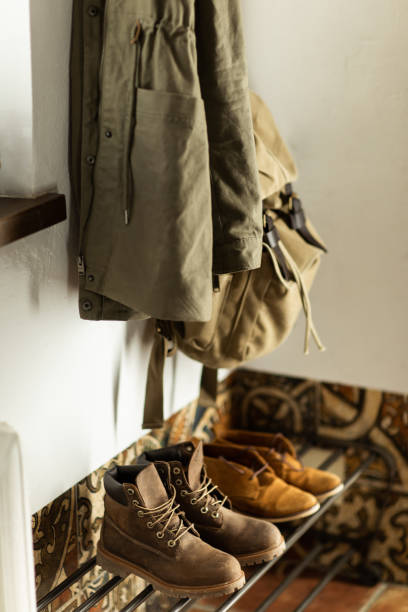 Autumn brown shoes and a backpack stand on a shelf in the hallway of the house Autumn brown shoes and a backpack stand on a shelf in the hallway of the house timberland arizona stock pictures, royalty-free photos & images