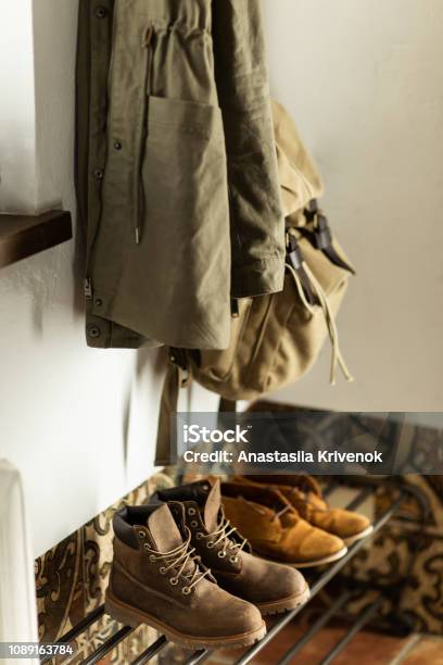 Autumn Brown Shoes And A Backpack Stand On A Shelf In The Hallway Of The House Stock Photo - Download Image Now