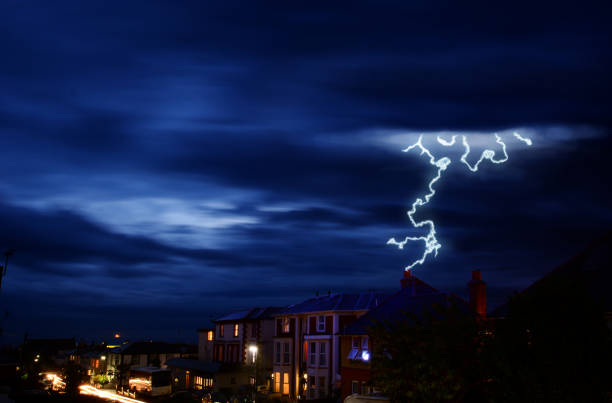 Lightning Storm Over Rooftops and Bay stock photo