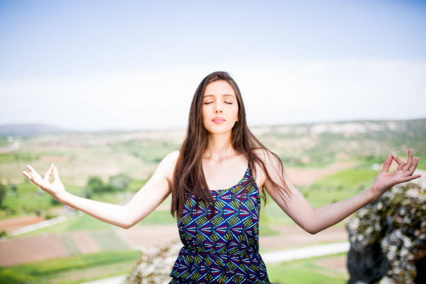 istock woman meditating in nature 1089171862