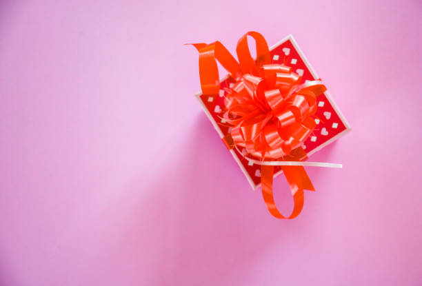 istock Gift Box red Valentines day concept / Red present box with ribbon bow on pink background 1089173232