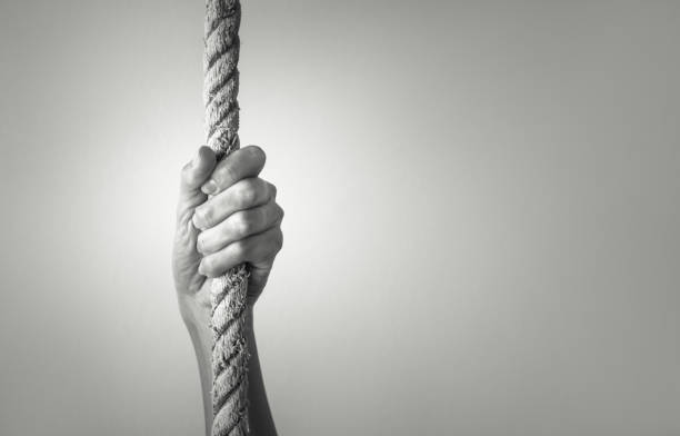 Hand holding tight onto rope.
