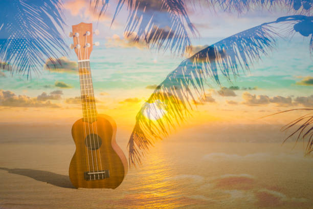 Beach island music Multi exposure image of a ukulele on the beach. Location Hawaii. ukulele stock pictures, royalty-free photos & images