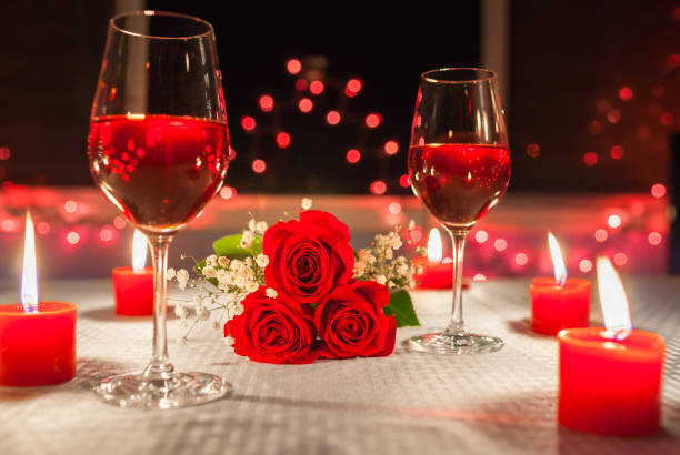 Romantic candlelight dinner Romantic candlelight dinner setting at the fine dining restaurant. rose bouquet red table stock pictures, royalty-free photos & images