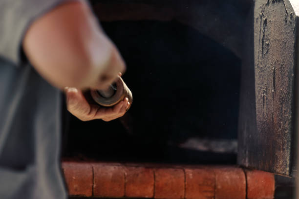 istock Man shovels the pizzas into a clay oven 1089181766