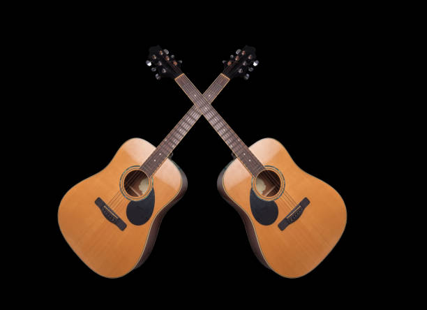Acoustic guitar is on the gray wall.