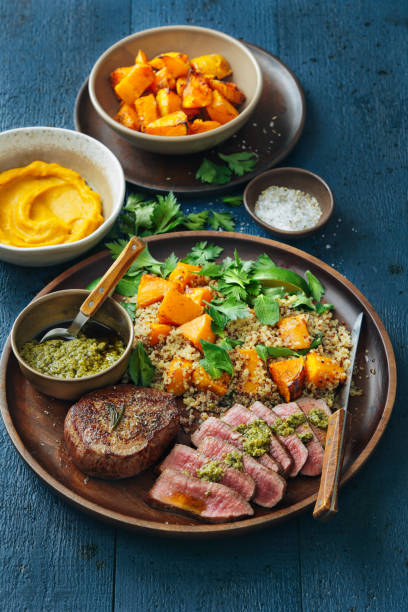 istock Filet mignon with chimichurri and quinoa salad with caramelised and mashed pumpkin 1089187650