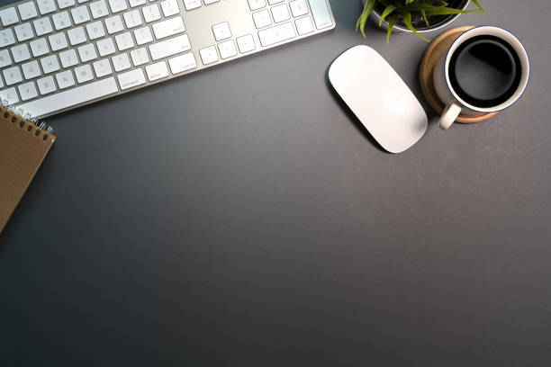 istock Office dark desk table workspace with computer, office supplies and coffee mug. Top view with copy space 1089191632