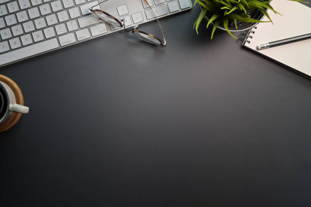 istock Top view of black office desk with keyboard computer, office supplies and copy space 1089191636