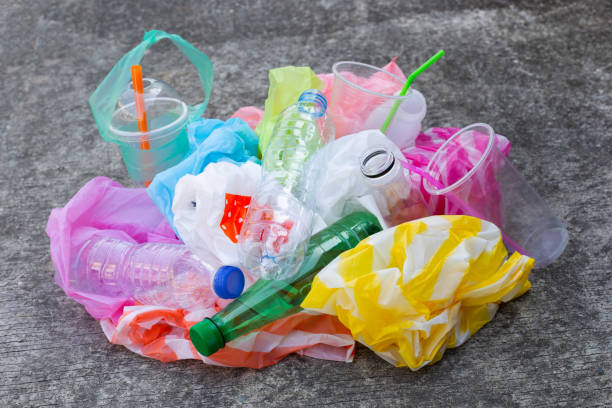 istock Colorful plastic waste, bags, cups, bottles, straws on cement floor 1089196812