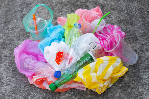 istock Colorful plastic waste, bags, cups, bottles, straws on cement floor 1089196914