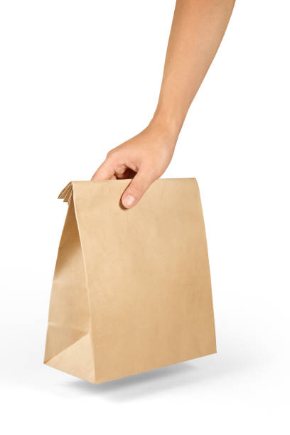 istock Right hand holdng a brown paper bag isolated on white with clipping path. 1089215986