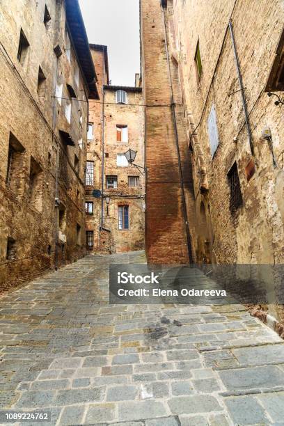 Medieval Narrow Street Vicolo Del Tone In Siena Tuscany Italy Stock Photo - Download Image Now