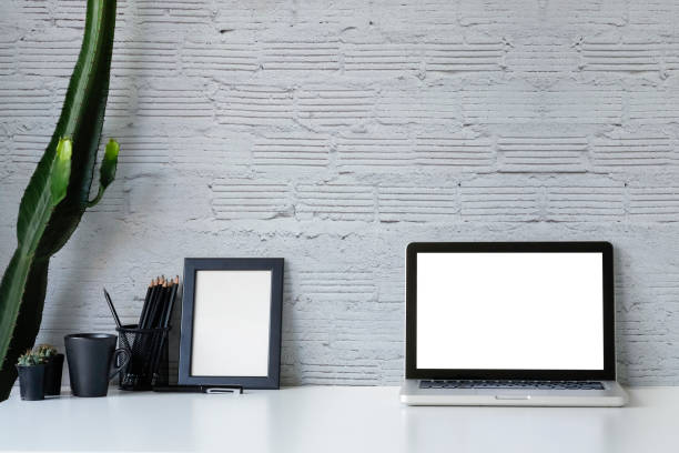 istock Workspace Mockup laptop, coffee and cactus on office table and office supplies with brick wall background. 1089229070