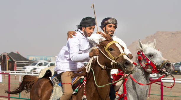 omani men riding their horses side by side Ibri, Oman, 28th April 2018: omani men riding their horses side by side arab man riding horse stock pictures, royalty-free photos & images