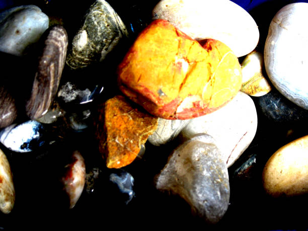 istock Bright orange colored rock on other stones 1089232236