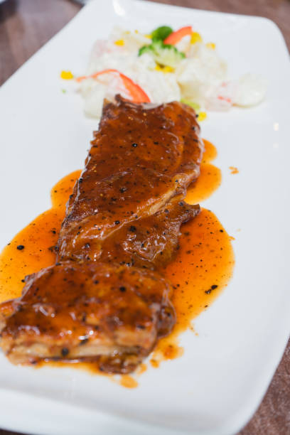 istock Pork grilled with sauce on white plate. 1089236896