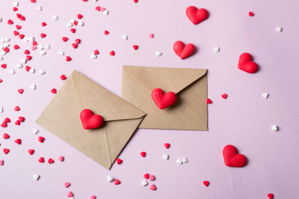 istock Two craft paper postal envelope with multicolor sweet sugar candy hearts. Love message or gift concept. 1089259412