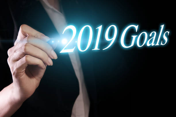 istock Hand holding a pen and writing 2019 goals 1089260456