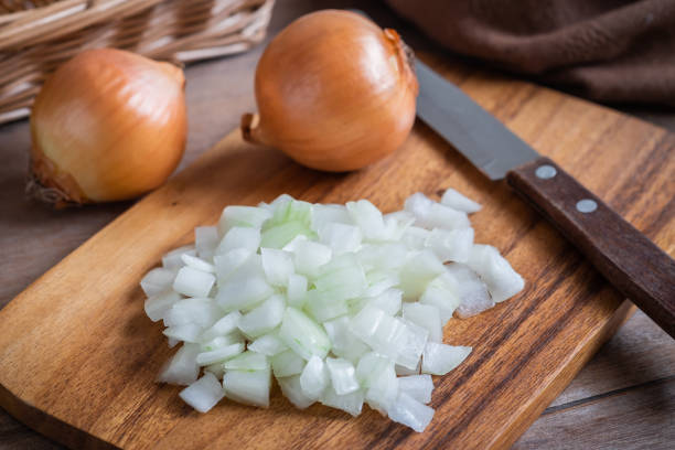 istock Fresh chopped onions on wooden cutting board 1089261724