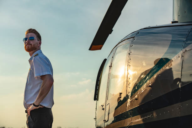 istock Helicopter pilot standing by the vehicle with hand on hip 1089262730