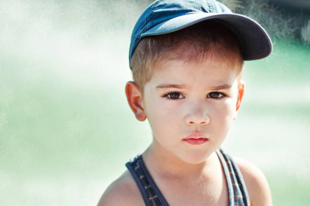 istock Cute boy looking sadly straight at camera 1089266870