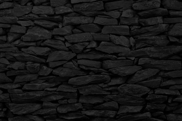 istock Black stone wall background, rock texture in natural pattern with high resolution for design art work. 1089267884